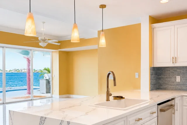 Fully remodeled modern kitchen with marble island and views of the waterfront