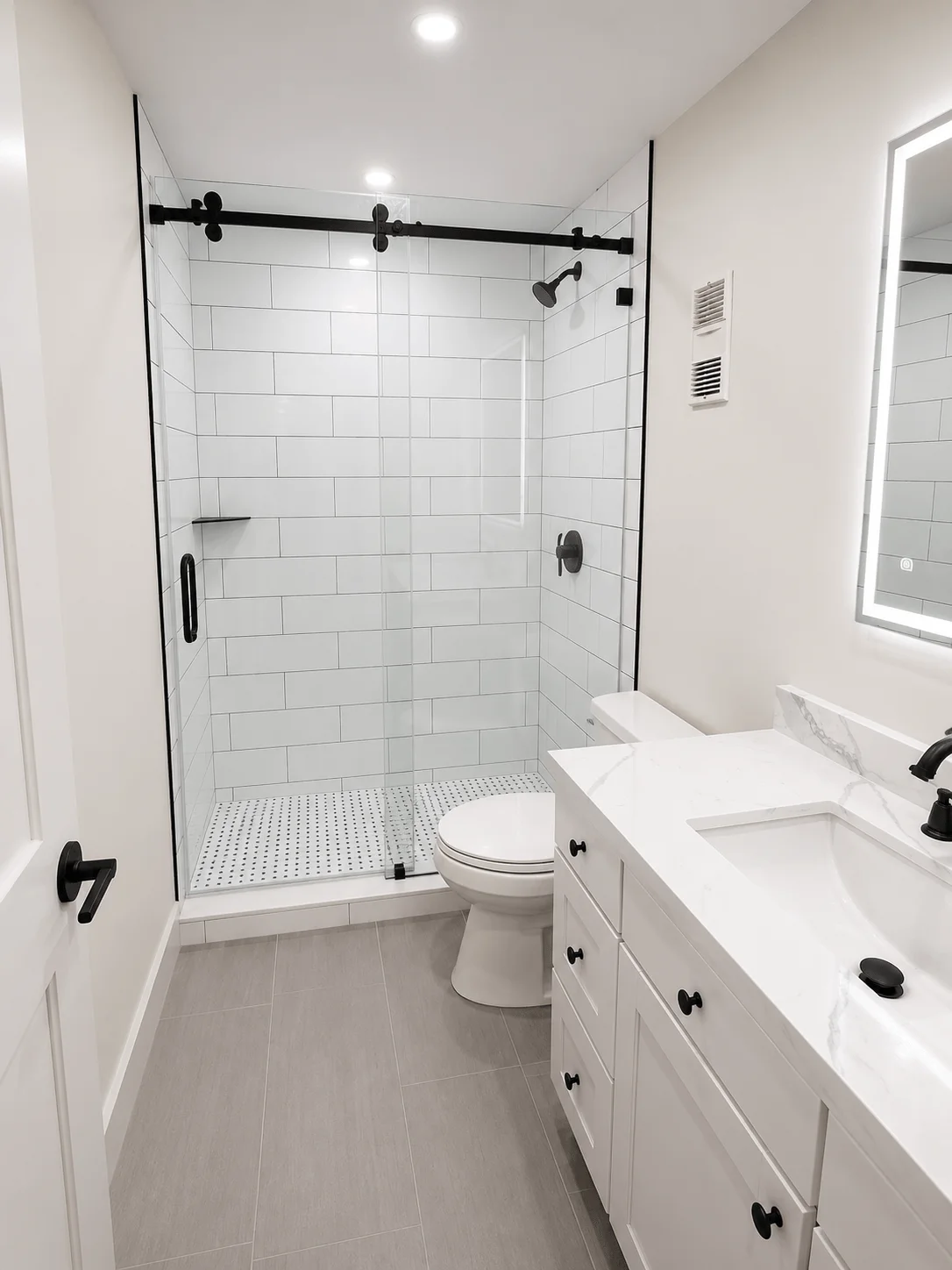 Contemporary white bathroom with glass shower enclosure and black fixtures